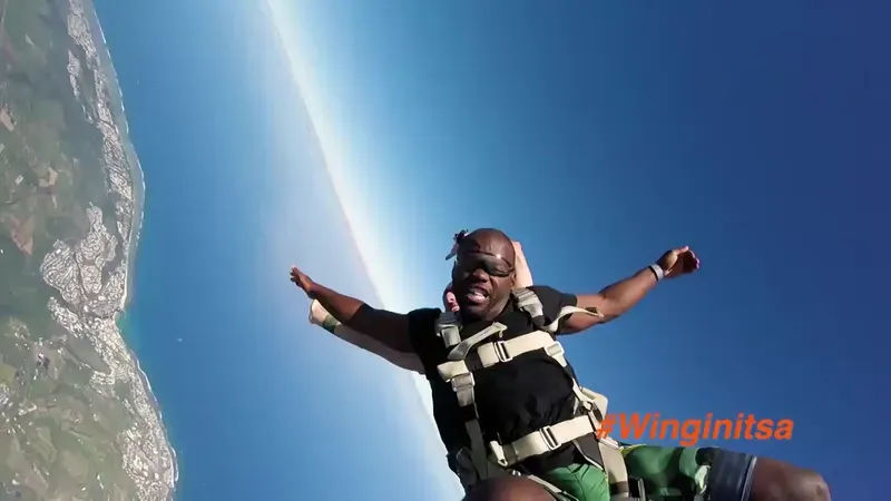 A presenter skydiving over the coast in Wingin' It